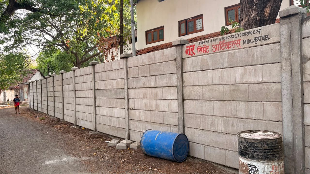 Precast compound wall installation beside a house